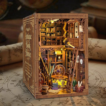 Myriad Books House DIY book nook kit displayed between books on a shelf